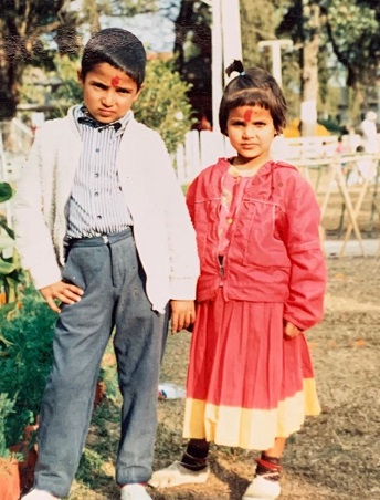 Aryan Sigdel with his sister in childhood